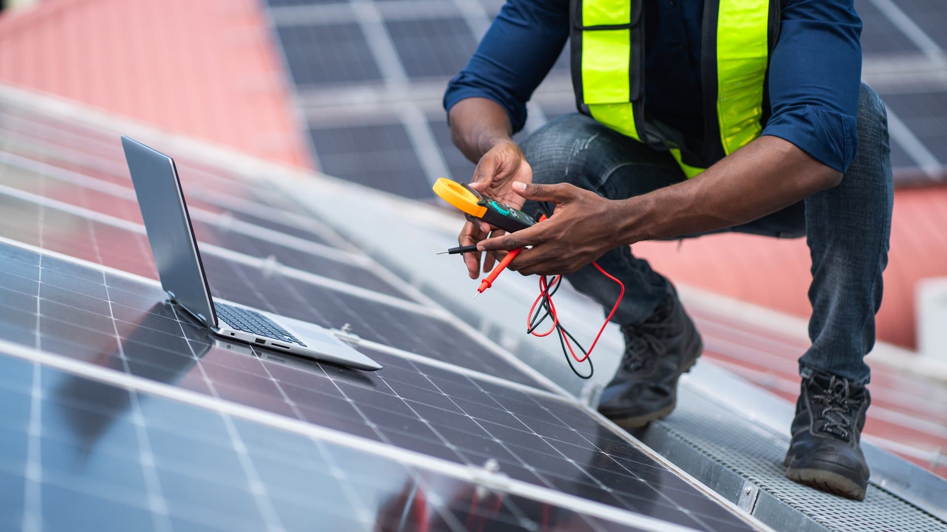 Service engineer checking solar panel on the roof for maintenance